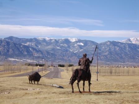 cowboy on a horse with mountains in distance