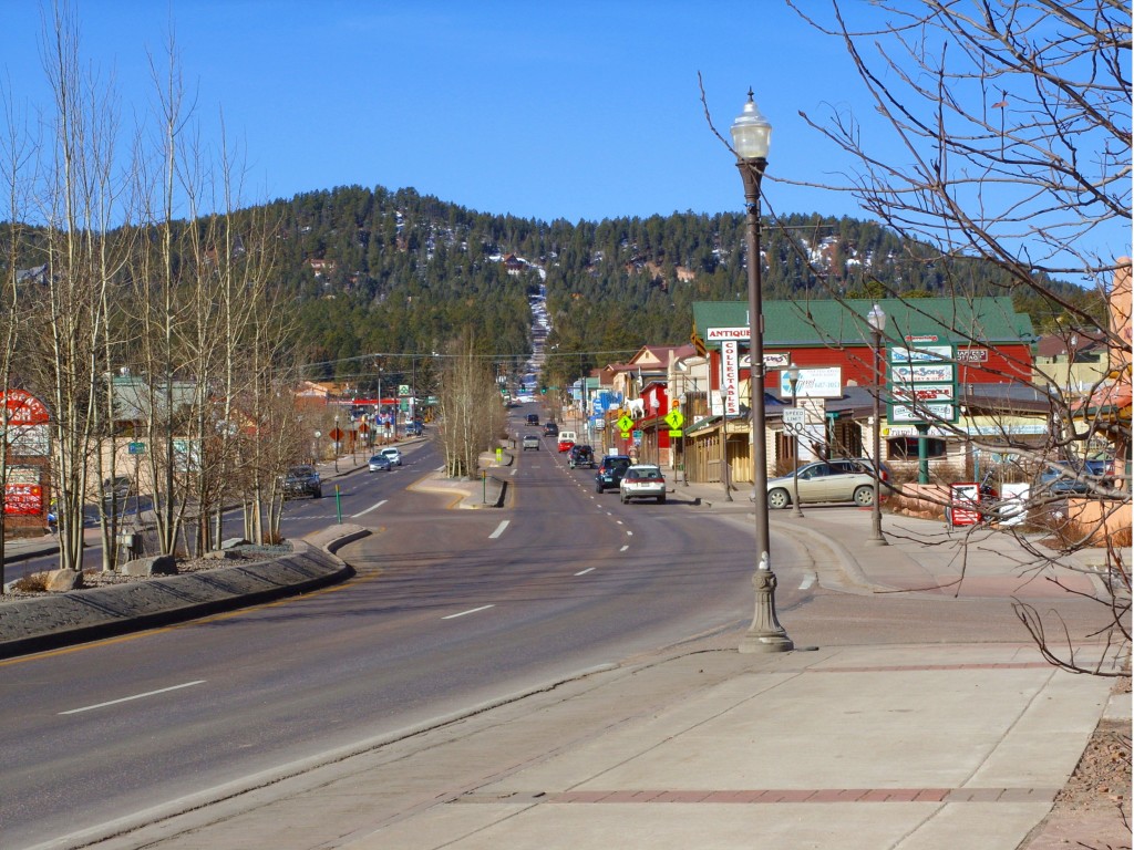 looking down the main street in woodland park colorado with rolling hills at the end